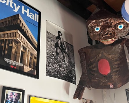 Pictures and alien model hanging on wall