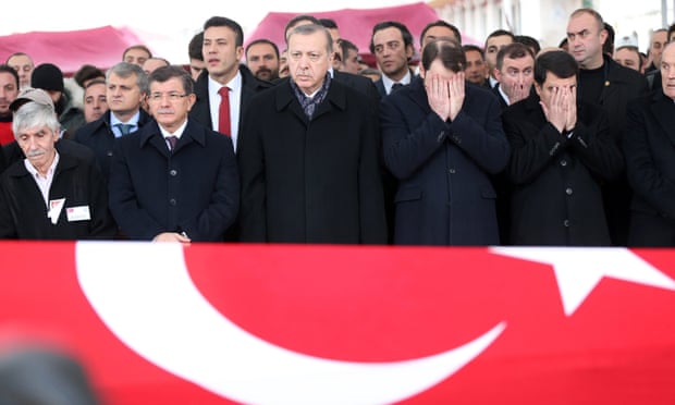 President Erdoğan (centre) mourns during the funeral of a police officer  killed in Saturday’s bomb attacks