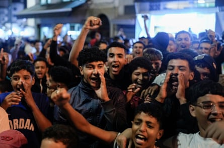 A group of children and young adults protest on street in Morocco.