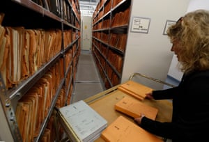 A member of the museum shows folders