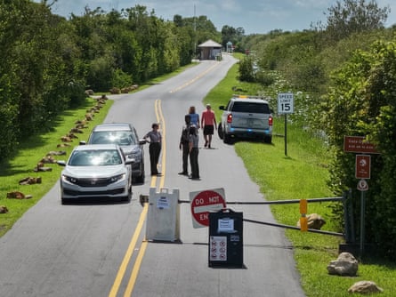 Park employees prepare to exit from a closed entrance