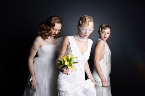 Three women are dressed in wedding gowns with hair done