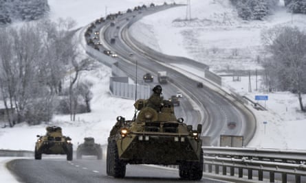 A convoy of Russian armoured vehicles moves along a highway in Crimea