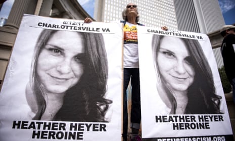 A demonstrator holds signs featuring Heather Heyer at a rally at downtown and at Trump Tower in Chicago, in August.