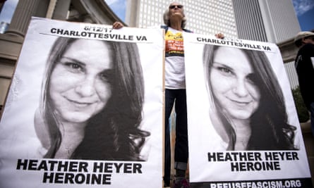 A demonstrator holds signs featuring Heather Heyer at a rally in Chicago, IL the day after white nationalists attacked counter-protesters in Charlottesville in 2017.