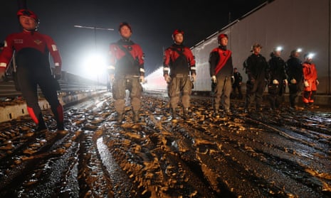 Rescue workers search for missing people along an underground tunnel in Cheongju.