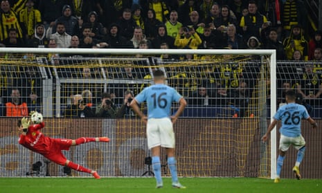 Riyad Mahrez of Manchester City has a penalty saved by Gregor Kobel of Borussia Dortmund