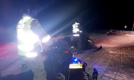 Police on snowmobiles search for the missing tourists in northern Quebec