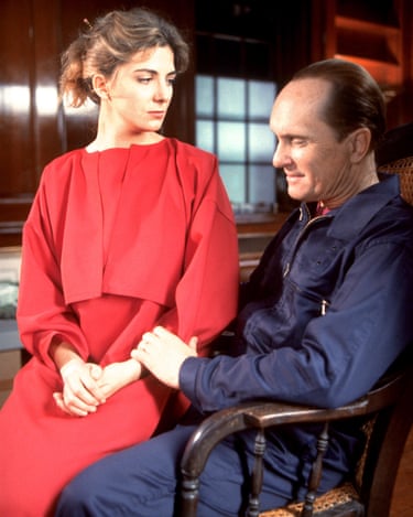 Natasha Richardson in a red dress sitting on Duvall's lap
