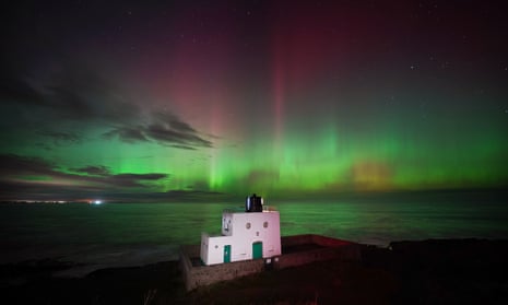 The aurora borealis, or northern lights, over Bamburgh lighthouse, Northumberland, 5 November 2023. 