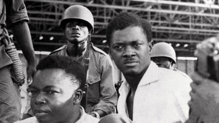 Soldiers stand guard over Patrice Lumumba and Joseph Okito