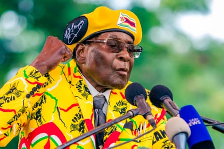 Robert Mugabe addresses party members and supporters in 2017 dressed in a bright yellow jacket and hat