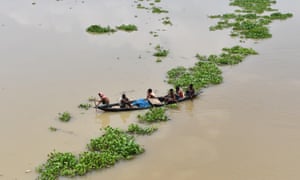 Indian villagers paddle a boat in the flood-affected Morigoan district in July last year. The relentless warming has highlighted the steep challenges faced by governments.