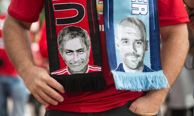 A scarf bearing pictures of José Mourinho and Pep Guardiola