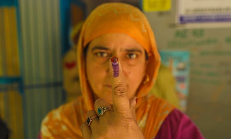 A Kashmiri Muslim woman shows her marked finger after casting her vote outside a polling station during the sixth phase of the Indian general elections on the outskirts of Anantnag in south Kashmir, the summer capital of Indian Kashmir, 25 May 2024.