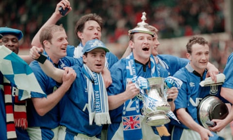 Everton captain Dave Watson celebrates with the trophy and team mates after Everton triumph in the 1995 FA Cup final against Manchester United.