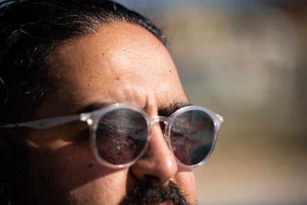 Mostafa Rachwani, the author, looks through his sunglasses at something in the distance