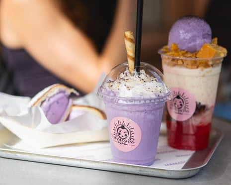 One purple drink in plastic cup, next to read and white drink with a scoop of purple ice-cream on top.