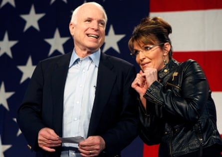 John McCain and Sarah Palin stand in front of a huge US flag