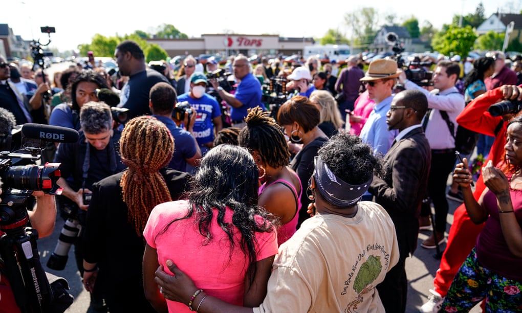 People gather outside the scene of a shooting at a supermarket, in Buffalo, New York, on Sunday.