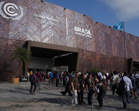 People pose for photos outside the venue for the Cop30 climate summit, in Belém, Brazil.