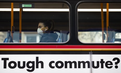 A masked passenger on a London bus