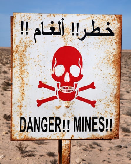 A landmine warning sign in Western Sahara. The desert wall is thought to be the world’s longest continuous minefield.