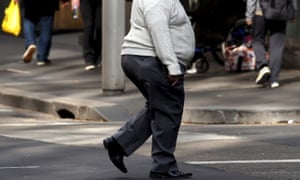 A man crosses a street in Sydney. Despite a reputation for sport and outdoor living, Australia has one of the fattest populations in the world.