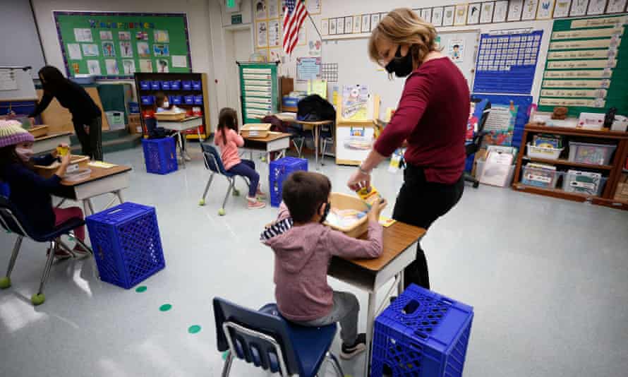 Jennifer Klein, a teacher at Lupine Hill elementary school in Calabasas, California, collects crayons from kindergarten students.