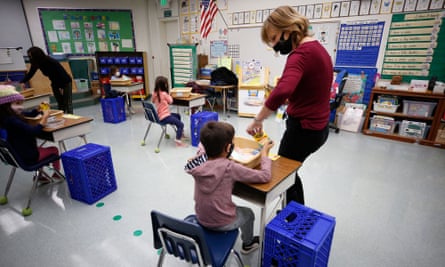 Jennifer Klein, a teacher at Lupine Hill elementary school in Calabasas, California, collects crayons from kindergarten students.