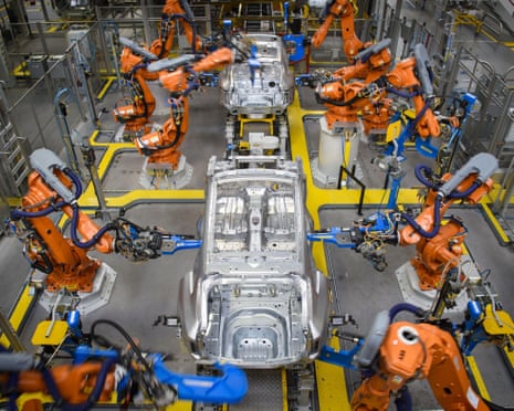 Robotic arms rivet car panels together at Jaguar Land Rover's plant in Solihull, West Midlands