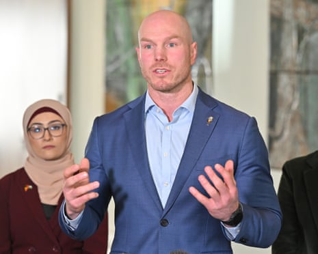 Senator David Pocock gestures while speaking at a press conference, with Senator Fatima Payman behind him