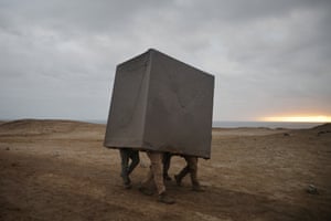 People walk under a box