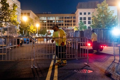 Workers set up security barricades outside the E. Barrett Prettyman US Courthouse in Washington, DC