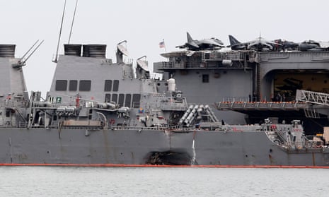 The damaged USS John McCain is docked next to USS America at Changi Naval Base in Singapore.