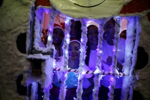 Inmates pose for photos through their festive prison bars