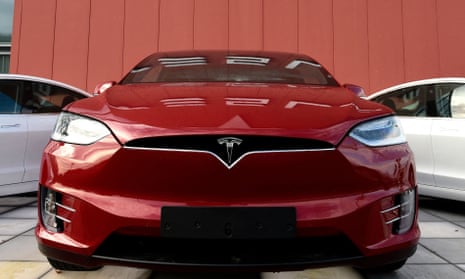 A red Tesla in a showroom