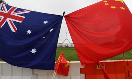Parliament House is seen behind an Australian and a Chinese flag in Canberra, Australia, 23 March 2017 (reissued 25 November 2019)