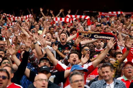 Arsenal fans inside the stadium cheer their team before the match against Leeds.