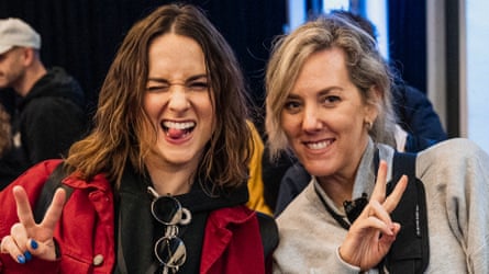 the two women make a face and hold their fingers up in a victory sign.