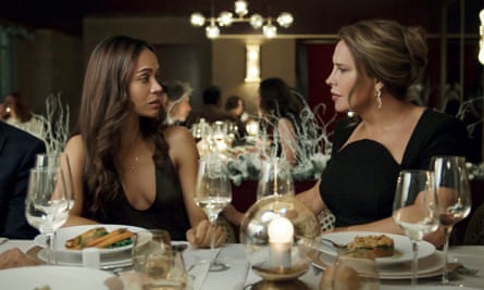two women in evening dresses at a dinner table