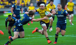 Michael Collins (left) and Aaron Smith of the Highlanders tackle Du’Plessis Kirifi of  the Hurricanes