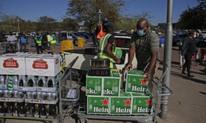 Workers help a customer load alcohol in his van moments after purchasing at Makro Silverlakes Liquor Store in Pretoria on June 1, 2020.
