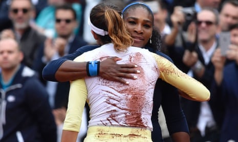 Spain's Garbine Muguruza (L) hugs the US's Serena Williams