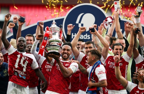 Arsenal’s Pierre-Emerick Aubameyang (centre) and teammates celebrate with the trophy.
