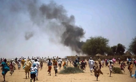 Crowds seen fleeing the fighting after the attack on Zamzam camp.