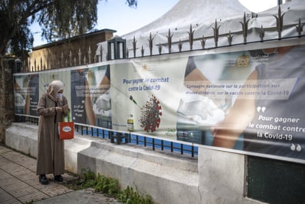 A woman walks past a temporary centre for clinical trials for Covid-19 vaccines, in Rabat, Morocco, on 7 December.