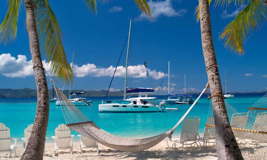 A hammock, beach and boat in the British Virgin Islands