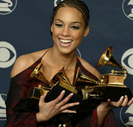 Top billing: Alicia Keys poses with the five Grammy Awards she won in 2002 in Los Angeles.