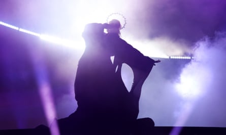 Madonna silhouetted on stage with a purple smoky background